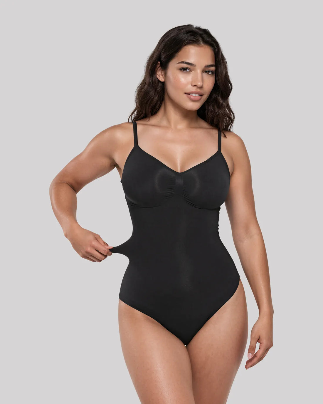 CYRA Sculpt Thong Bodysuit in Onyx — front view on model