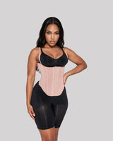 Sandstone — CYRA Sculpt Vest Waist Trainer, front view on model, worn over a black bra and black shorts